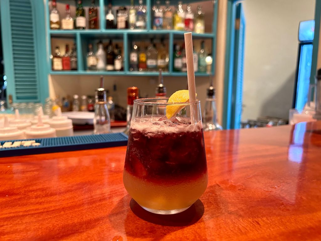 A beautiful cocktail with orange on the bottom and red on the top from the bar at Castaways Barbados