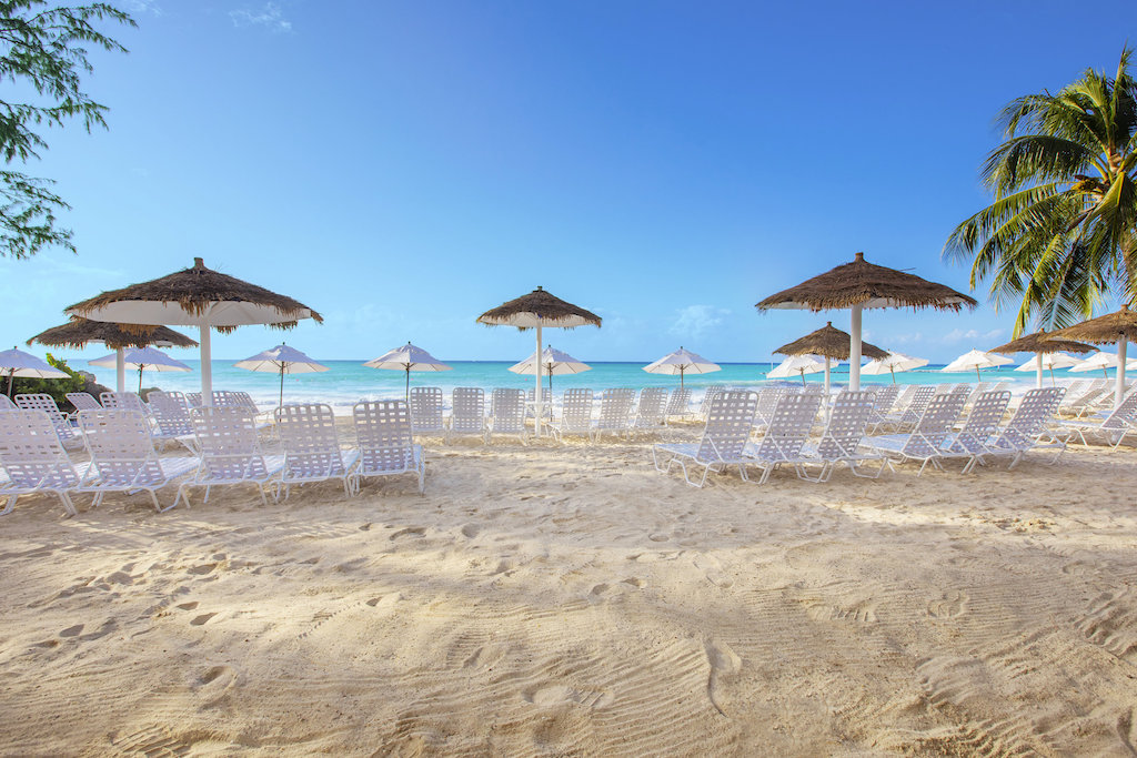 white chairs facing the ocean at Bougainvillea Resort Barbados