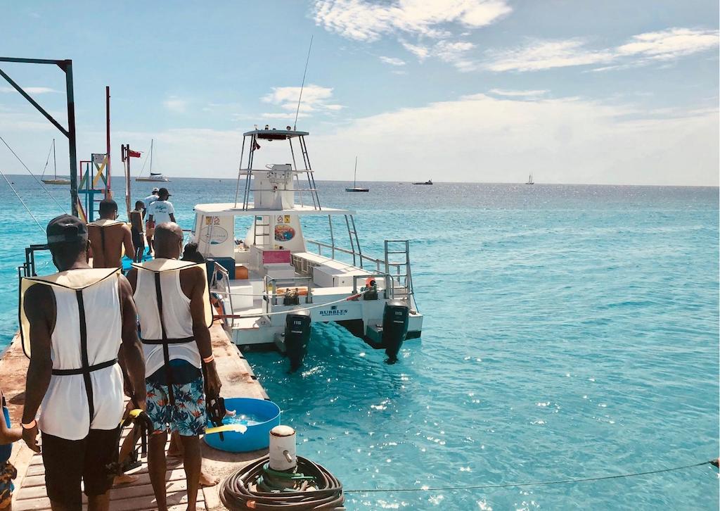 guests lining up to board a snorkeling tour at Boatyard beach club
