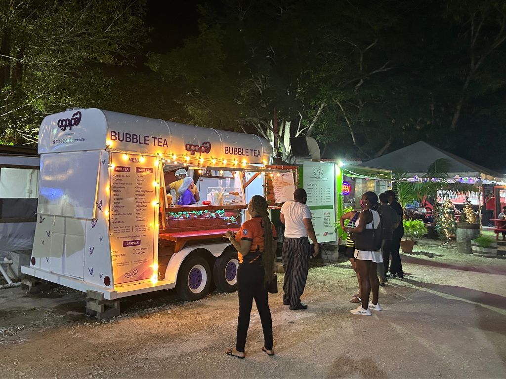 Guests lined up outside food trucks at Worthing Square Barbados