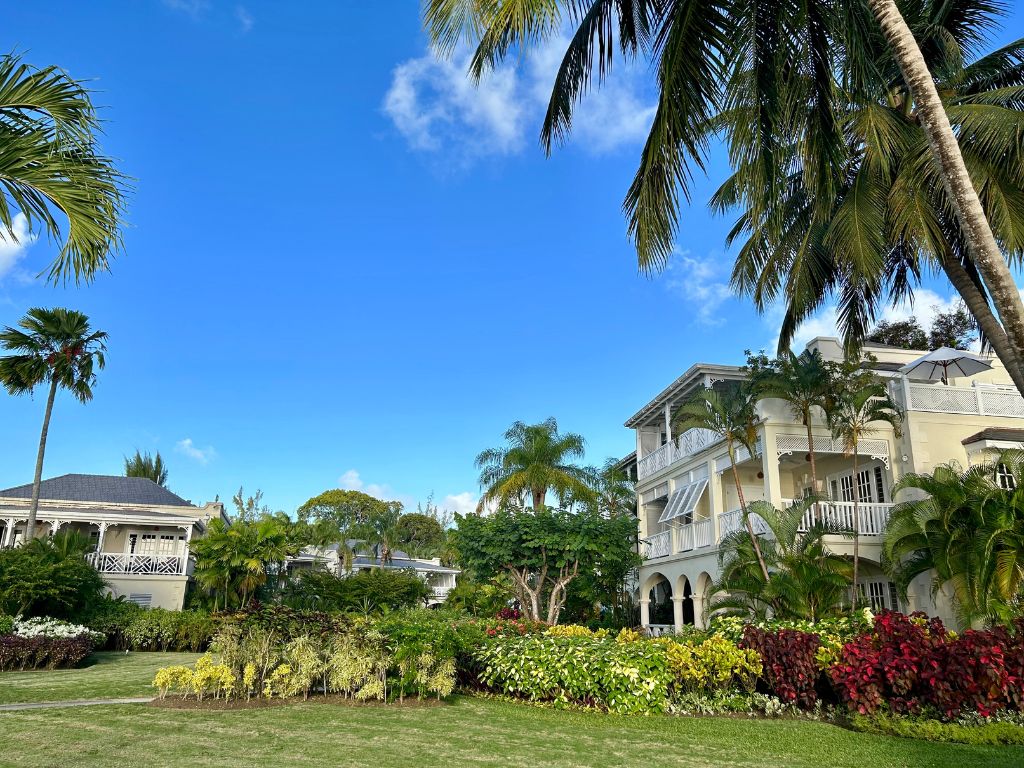 The grounds of Coral Reef Club, A luxurious resort with gardens and palm trees and one of the best places to stay in Barbados for a luxury holiday